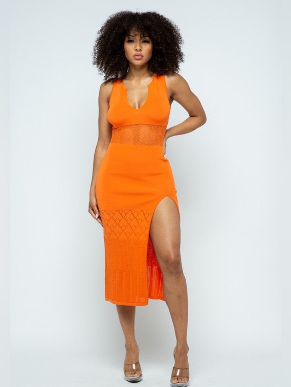 Orange sleeveless knit midi dress with a thigh high slit.